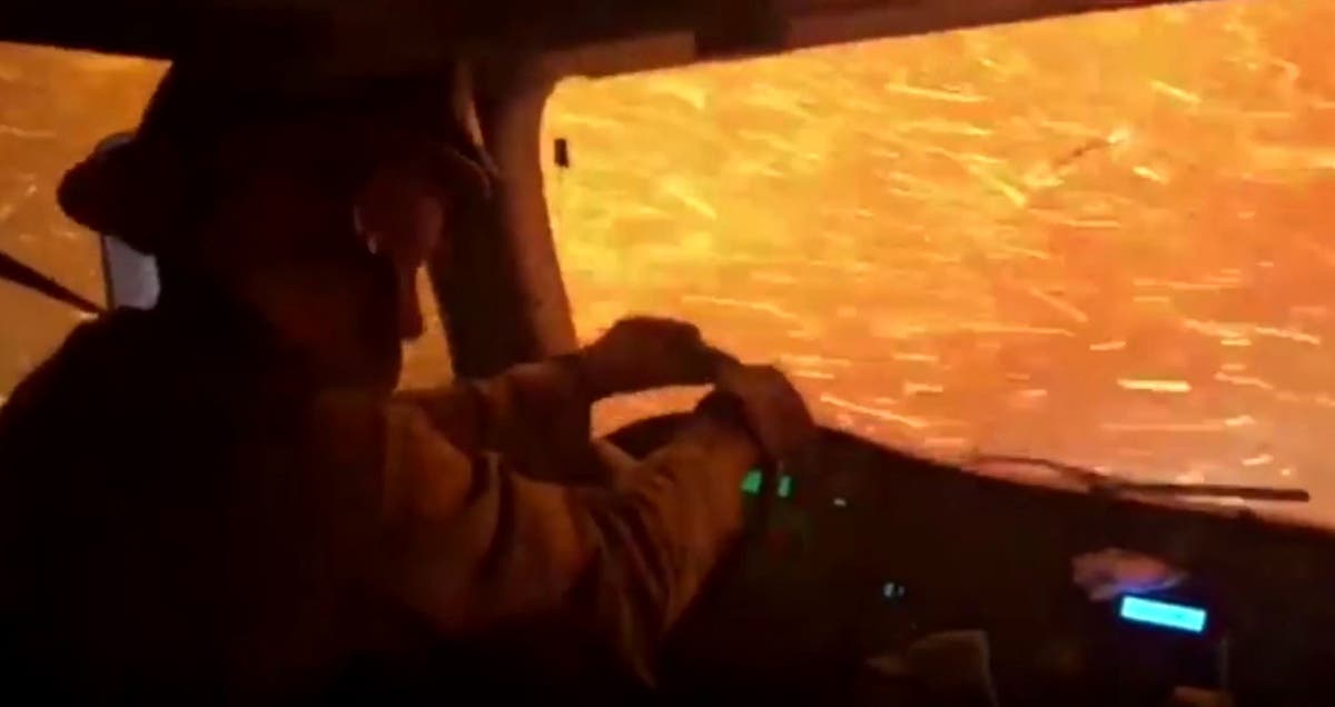 Video shows firefighters driving into wall of flames in California