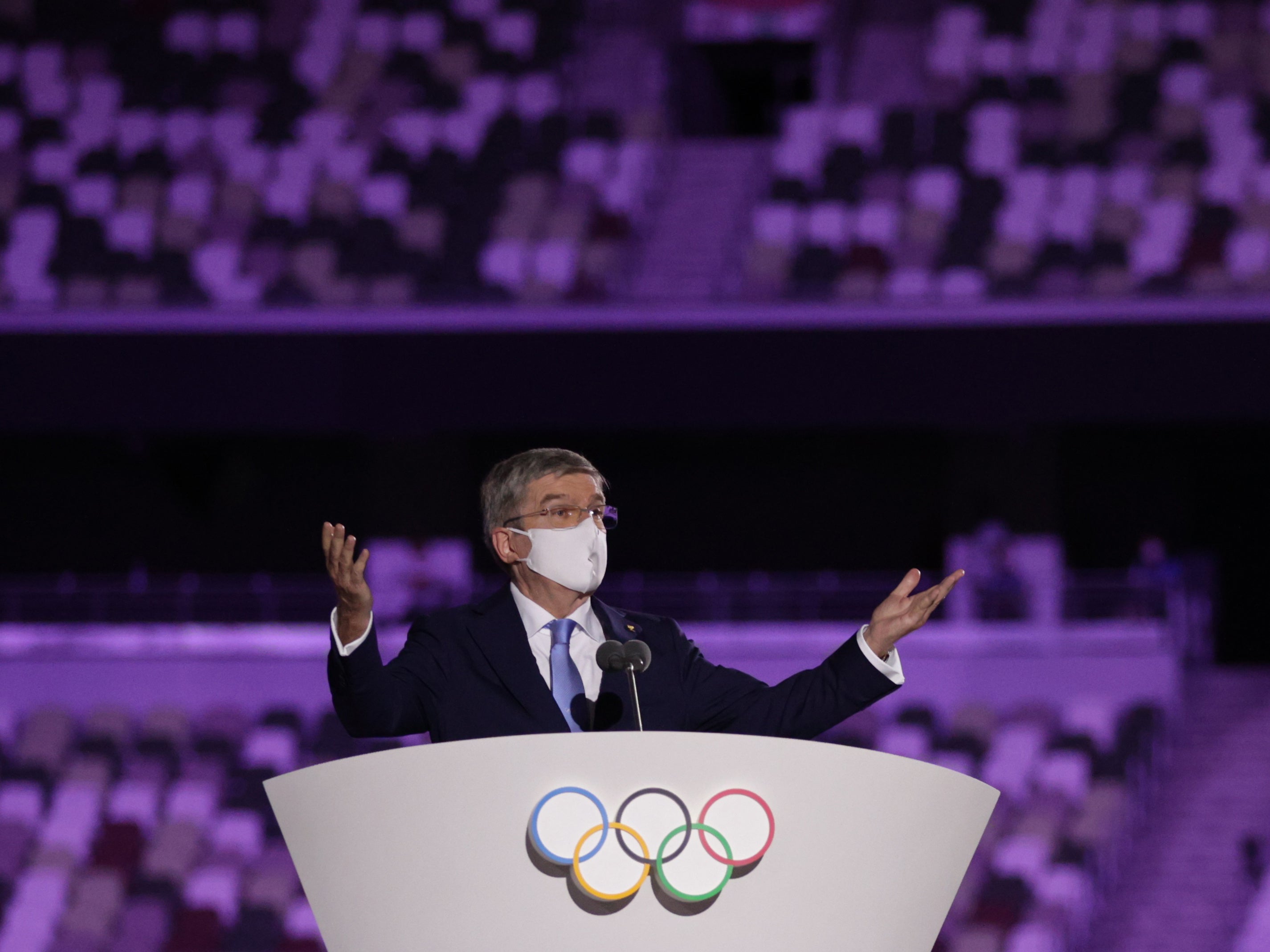 International Olympic Committee (IOC) President Thomas Bach wearing a protective face mask speaks during the opening ceremony.