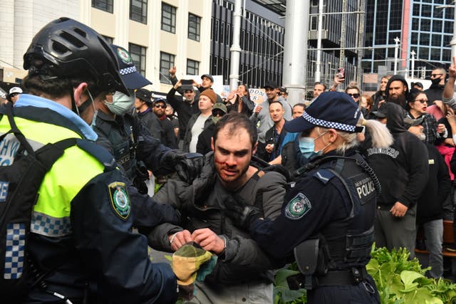 <p>Protesters are arrested at Sydney Town Hall on Saturday</p>