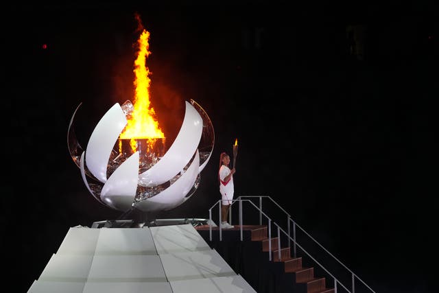 <p>Naomi Osaka lights the Olympic flame during the opening ceremony of the Tokyo 2020 Olympic Games (Martin Rickett/PA Images)</p>