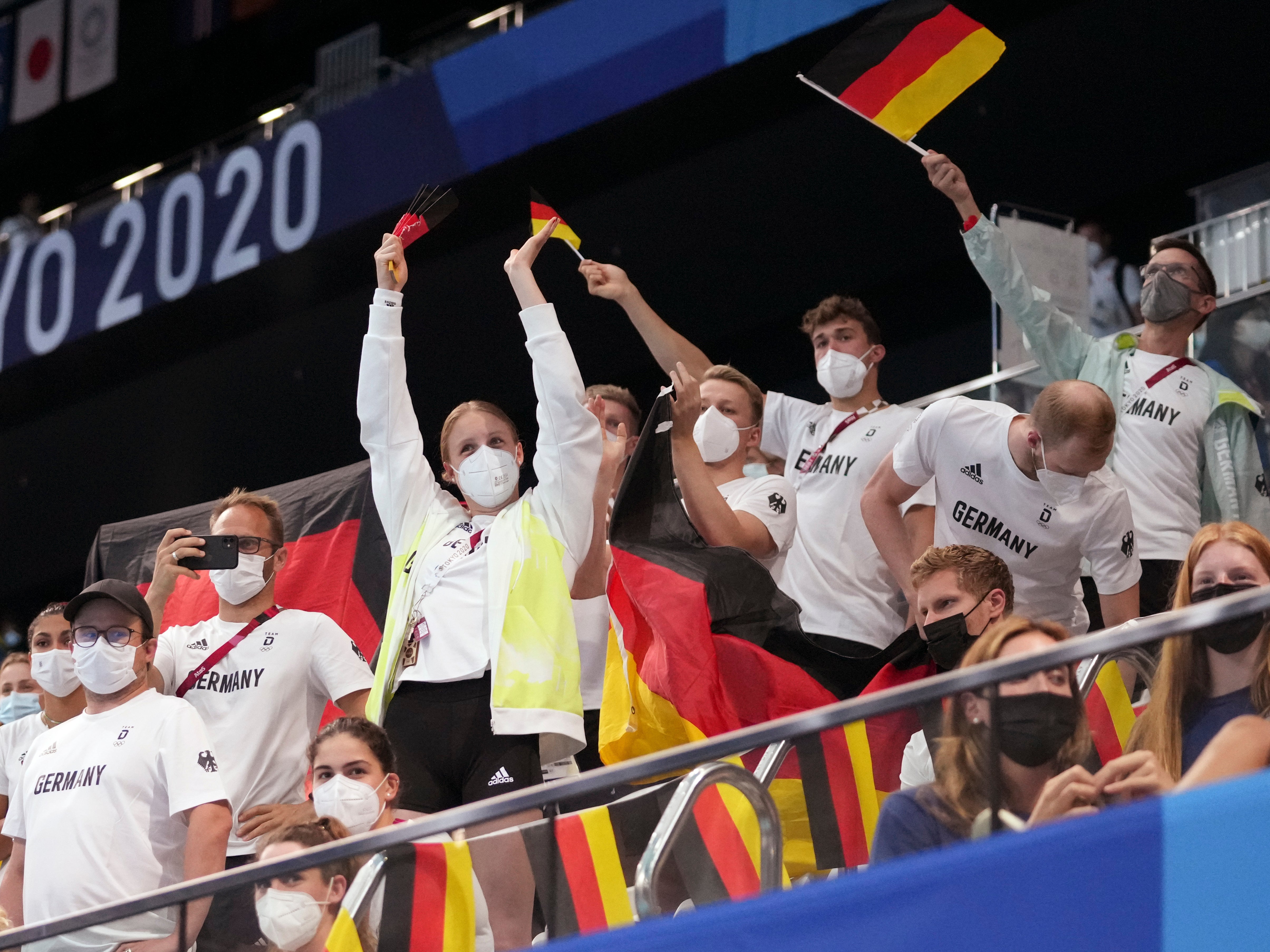 German swim team members cheer on their teammates during swimming competitions at the 2020 Summer Olympics, Saturday, July 24, 2021, in Tokyo, Japan.