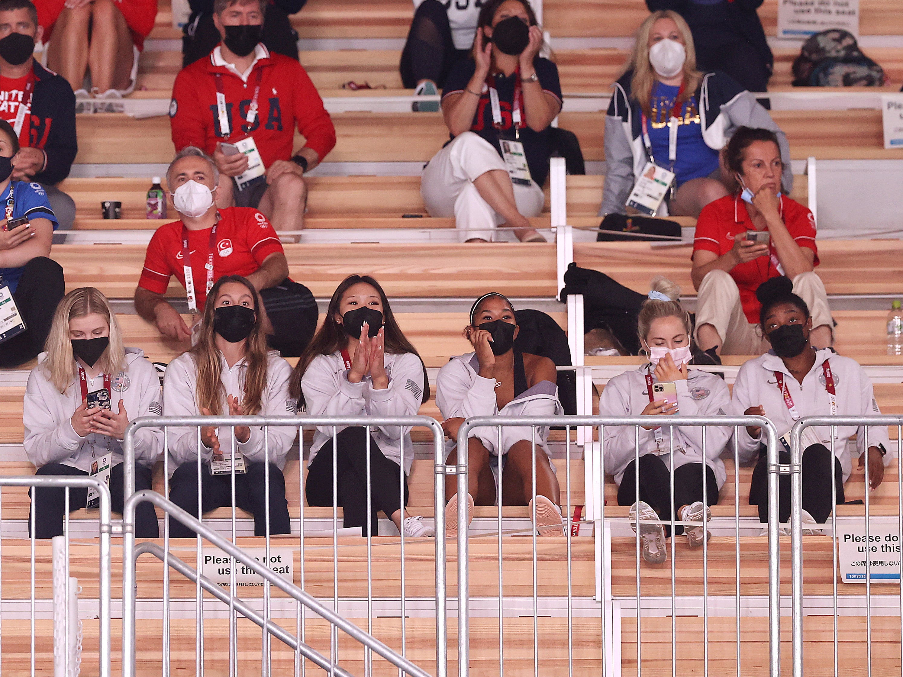 Members of the US women’s gymnastics team attend the men’s qualifications on day one of the Tokyo 2020 Olympic Games at Ariake Gymnastics Centre on July 24, 2021 in Tokyo, Japan.