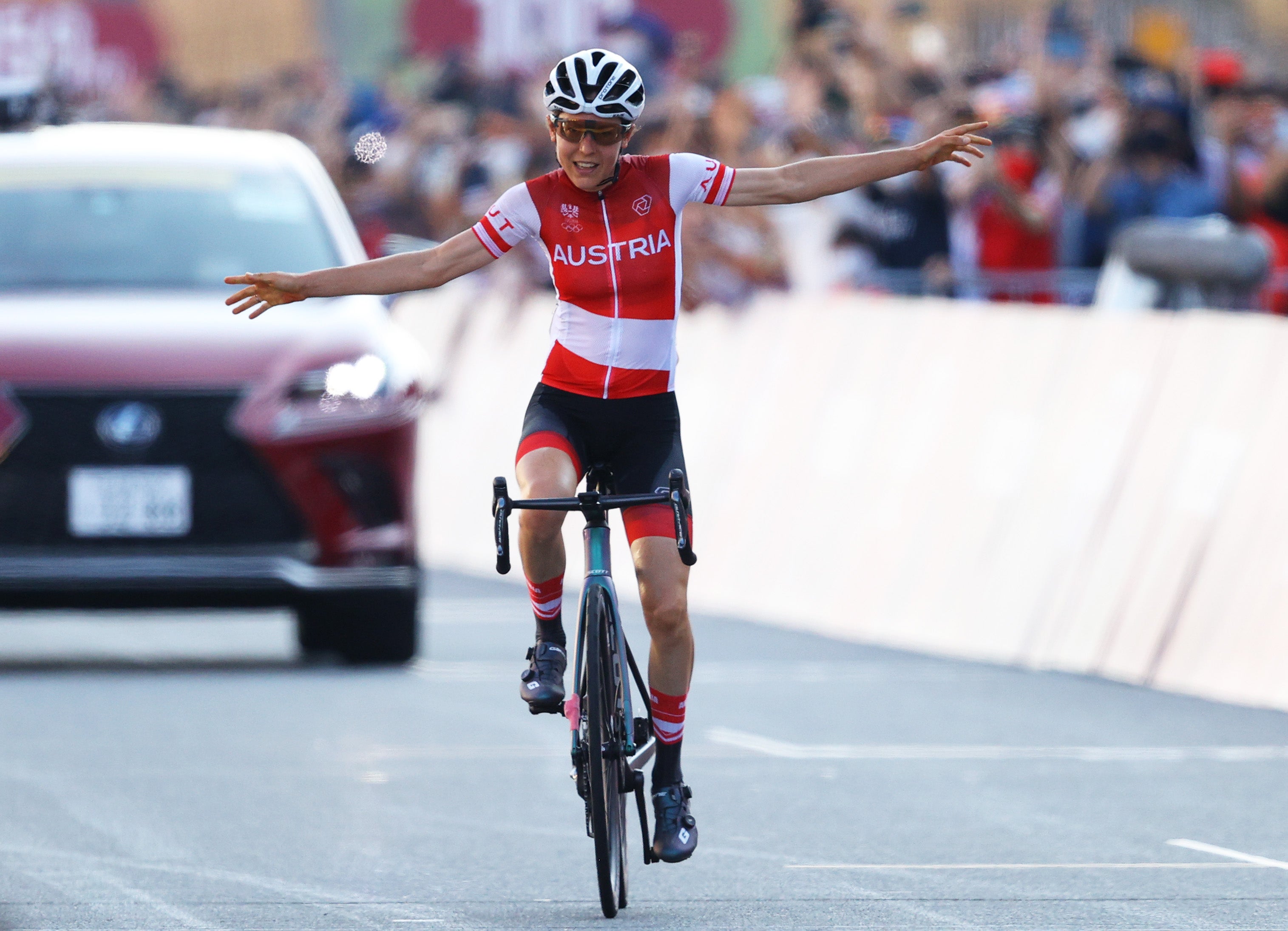 Anna Kiesenhofer celebrates winning a shock gold for Austria