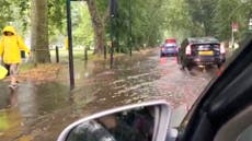 Heavy rains flood roads around London’s Clapham Common