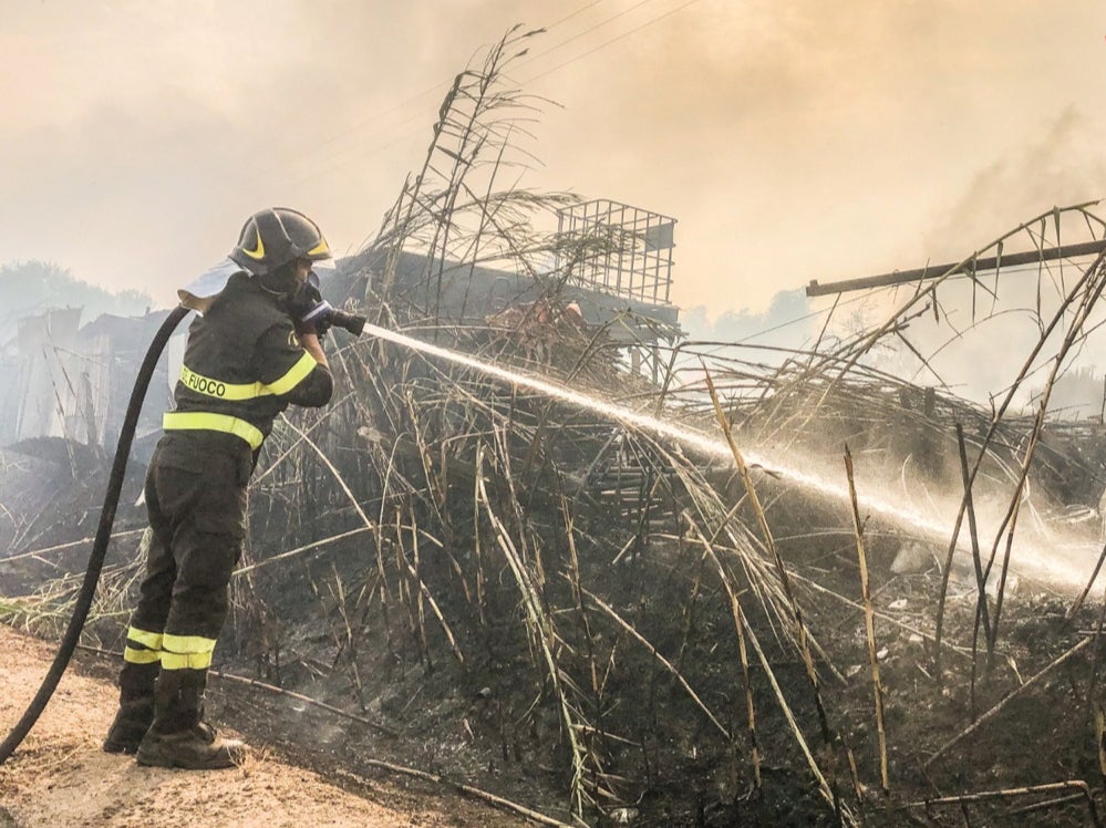 A firefighter battles the flames near Santu Lussurgiu in Sardinia