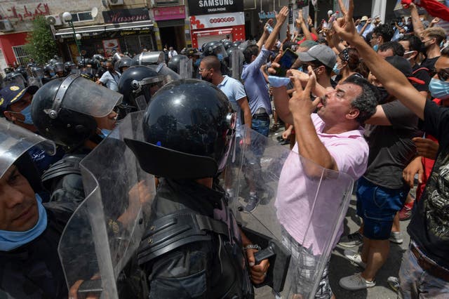 <p>Members of Tunisian security forces face off with anti-government demonstrators during a rally in front of the Parliament in the capital Tunis on 25 July, 2021</p>