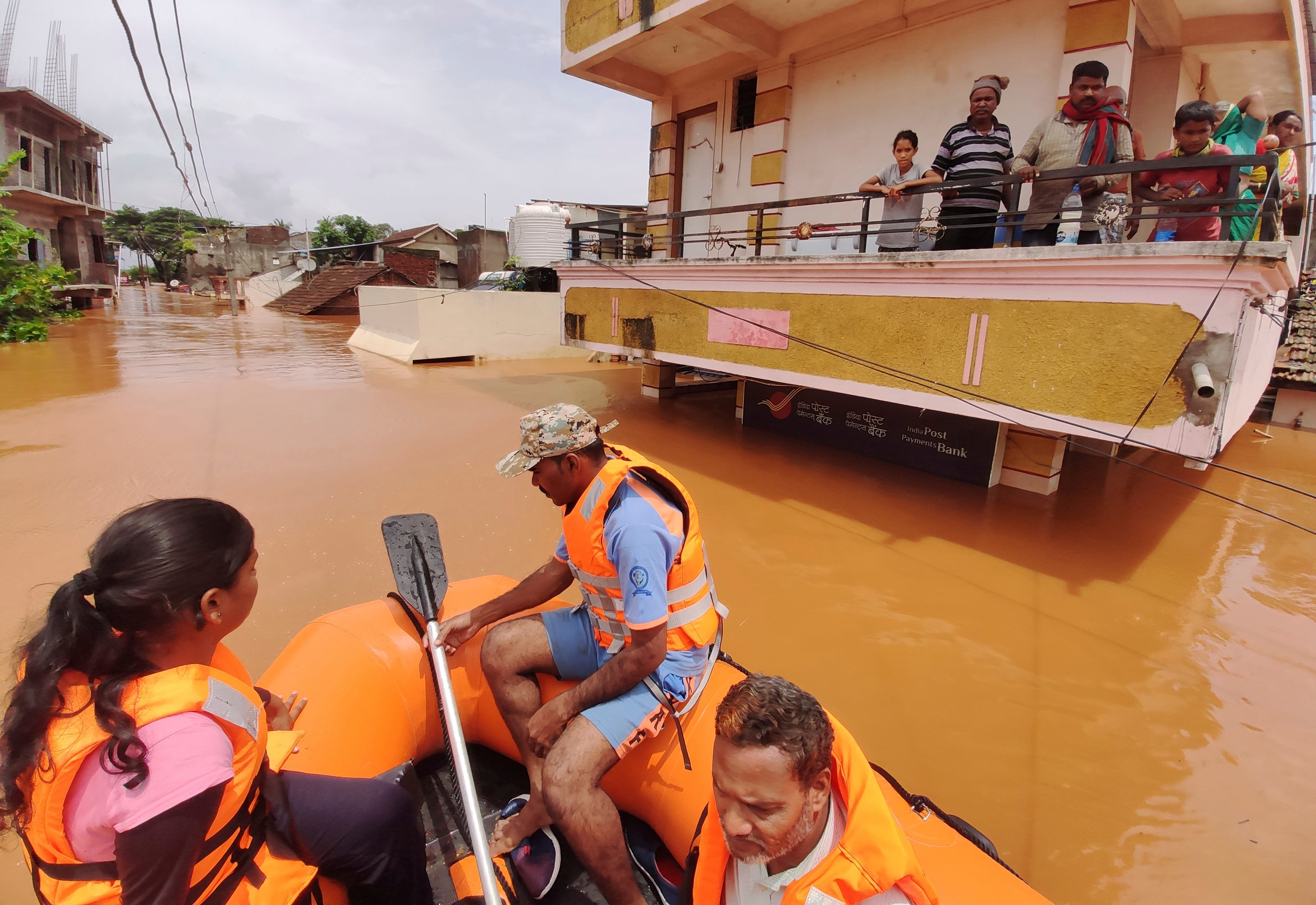 People await for help on top floor of their house after village submerged in water at Kolhapur in western Maharashtra state, India