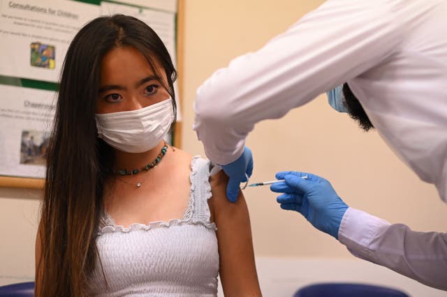 <p>A student is given a dose of the Pfizer/BioNTech Covid-19 vaccine at a vaccination centre at the Hunter Street Health Centre in London</p>