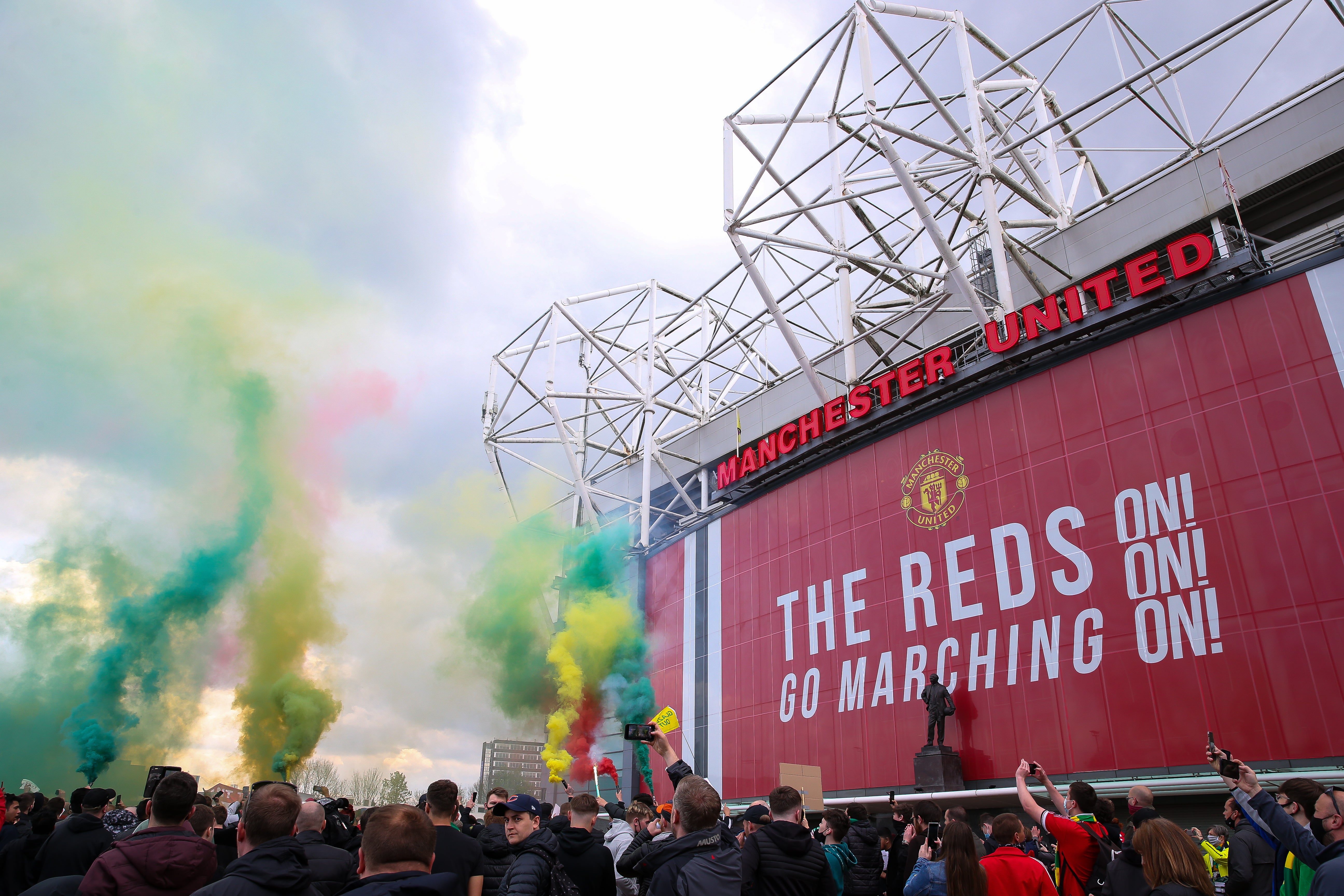 Fans let off flares as they protest against the Glazer family (Barrington Coombs/PA)