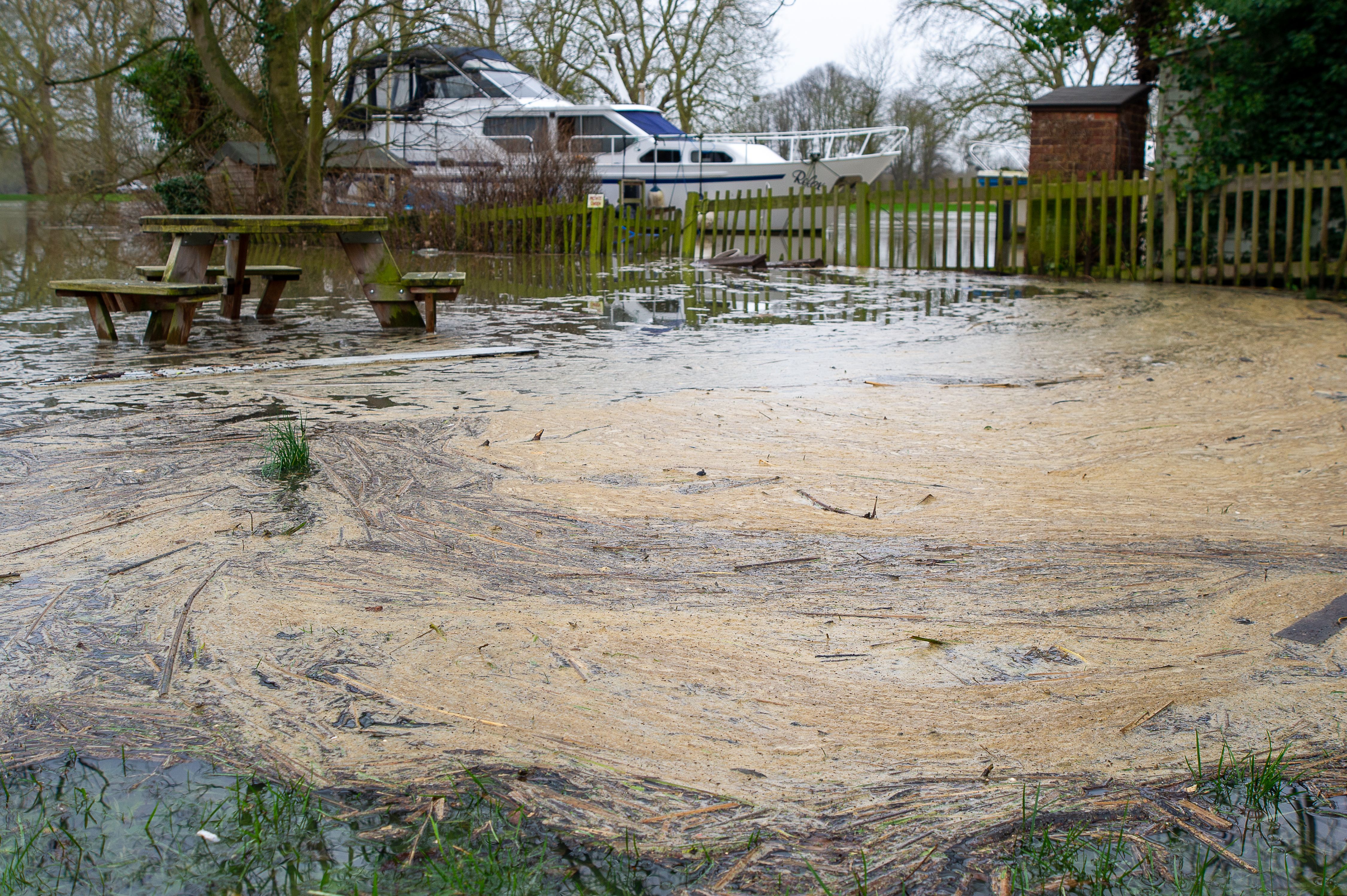 Pollution gathers in a flooded picnic area by the Thames in Datchet