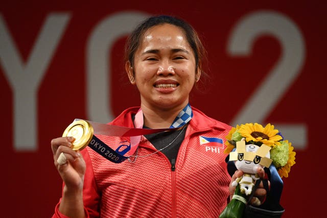 <p>Gold medallist Philippines' Hidilyn Diaz stand on the podium for the victory ceremony of the women's 55kg weightlifting competition during the Tokyo 2020 Olympic Games at the Tokyo International Forum in Tokyo on July 26, 2021</p>