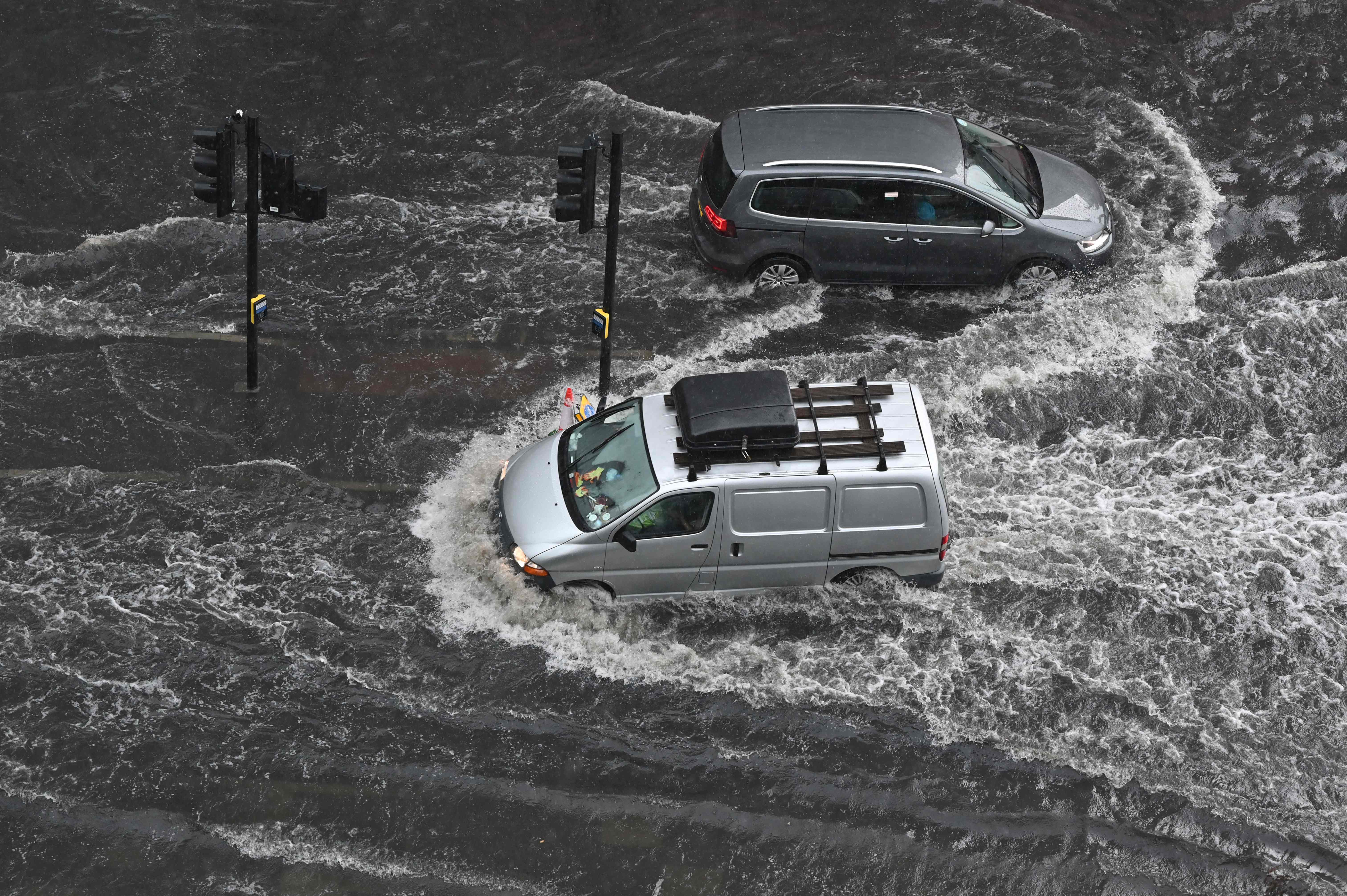 A flooded road in Nine Elms , London, on Suunday after extreme heat triggered torrential rain