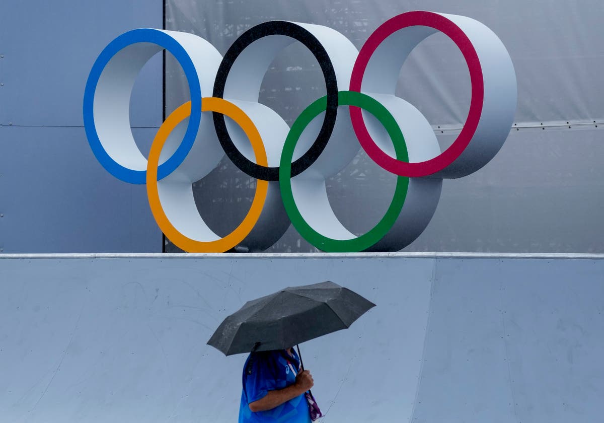 GLIMPSES: As rain arrives and typhoon nears, Olympics endure