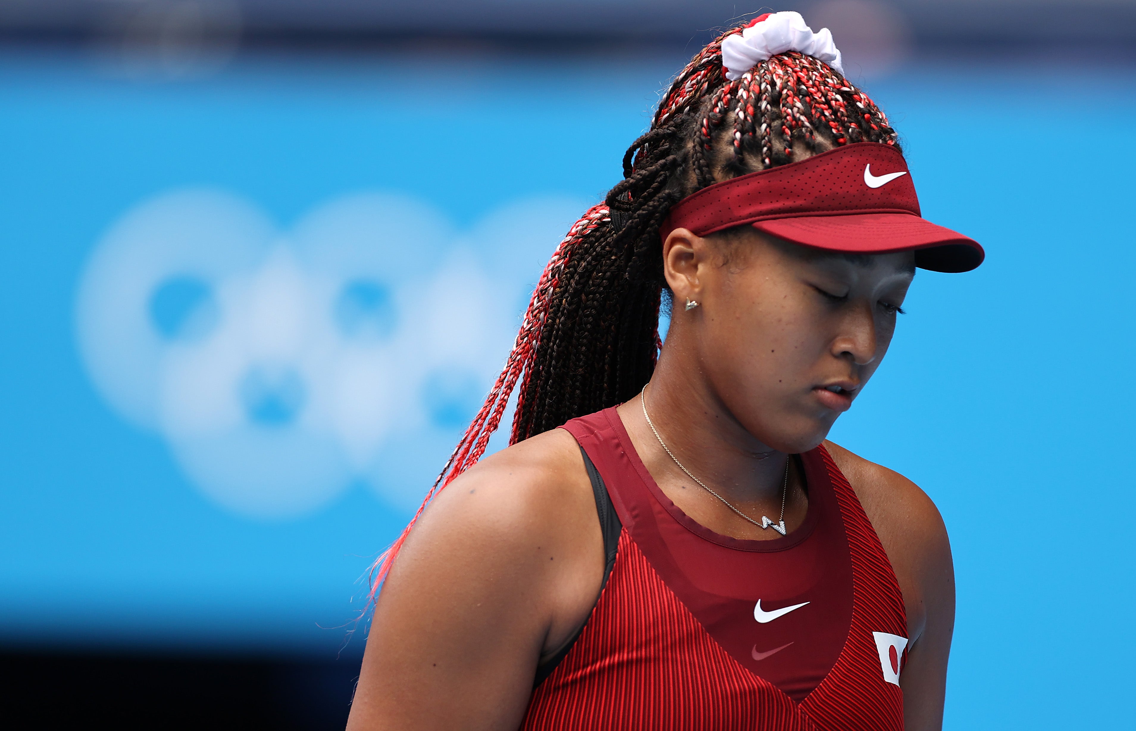 Naomi Osaka of Team Japan prepares to receive serve during her Women's Singles Second Round match against Viktorija Golubic of Team Switzerland on day three of the Tokyo 2020 Olympic Games at Ariake Tennis Park on 26 July 2021 in Tokyo, Japan