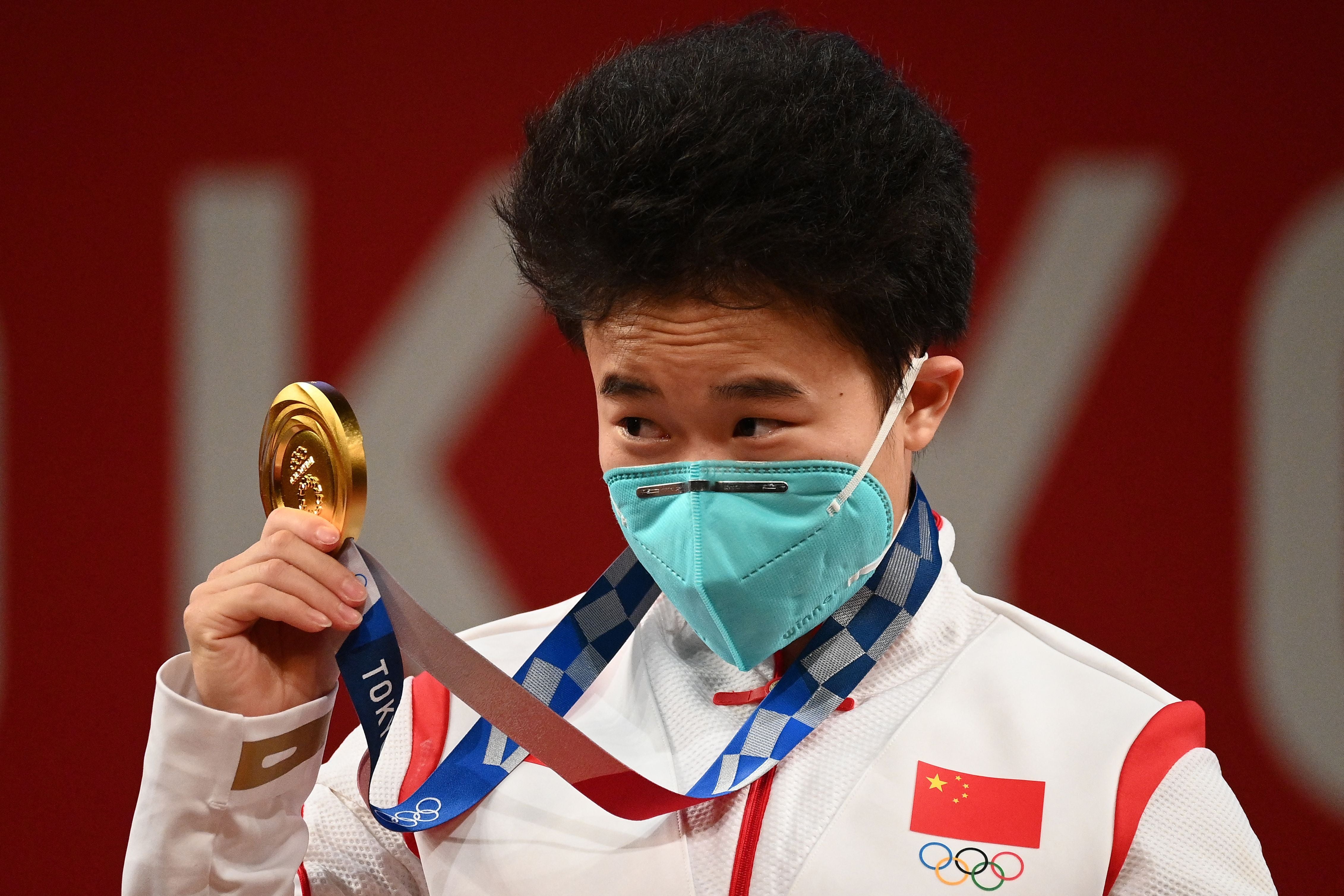 China’s Hou Zhihui stands on the podium after winning gold