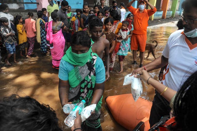 <p>India's National Disaster Response Force (NDRF) personnel distribute food and relief material to people impacted by floods in Maharashtra </p>