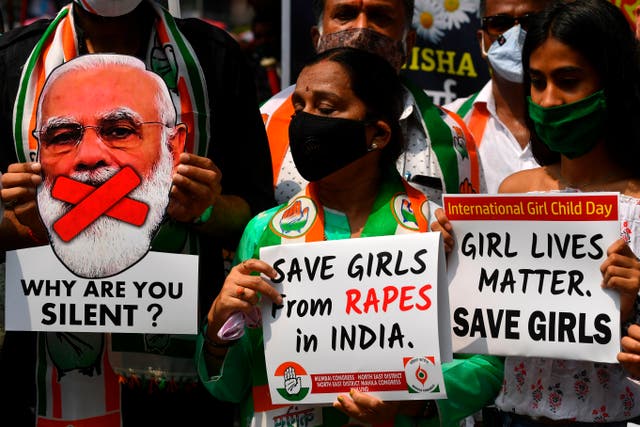 <p>File. Political activists hold placards and a cut-out of India’s Prime Minister Narendra Modi during a protest to condemn the alleged gang-rape and murder of a teenaged woman in Bool Garhi village at Hathras in Uttar Pradesh </p>