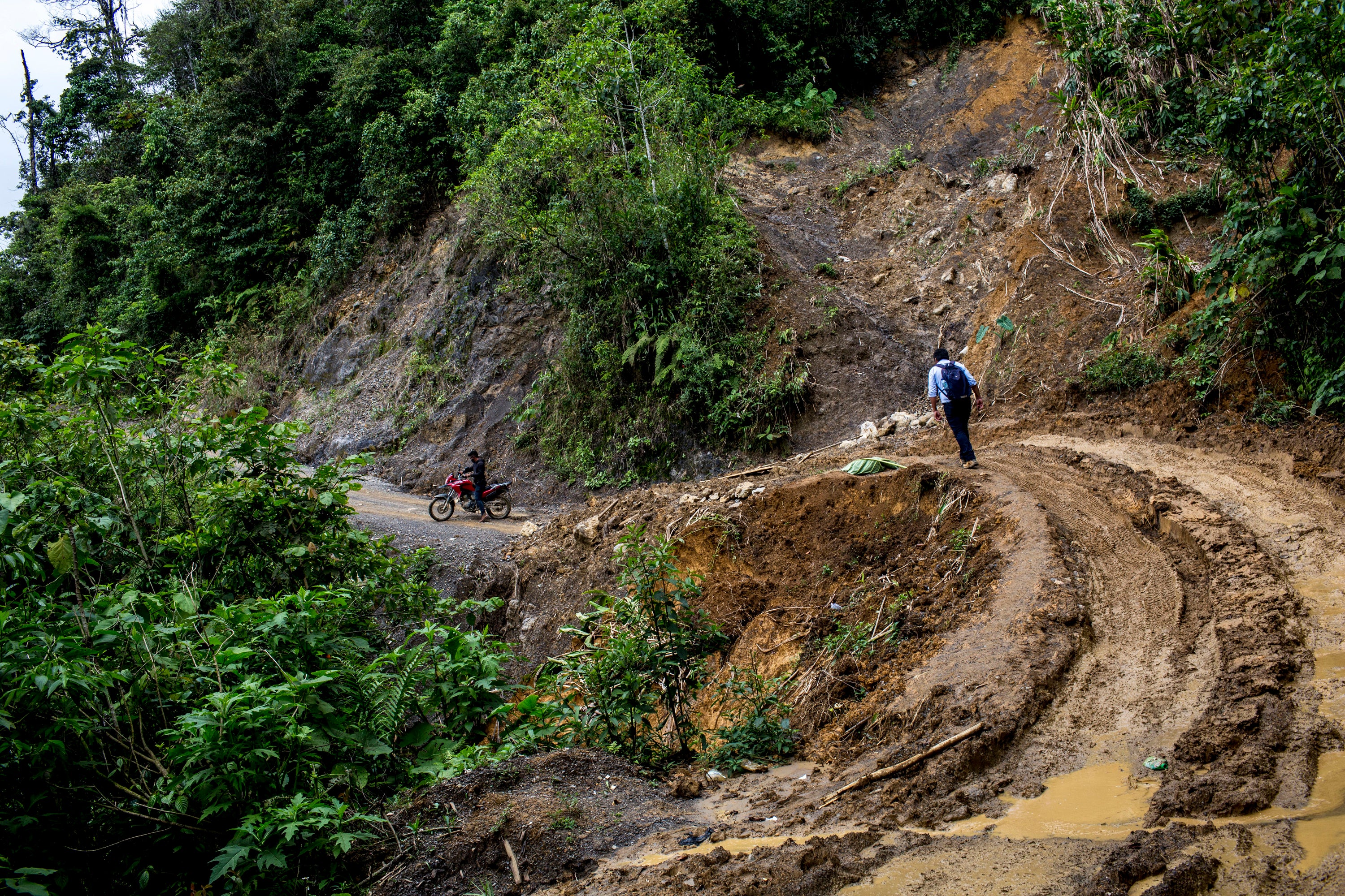 Eriberto Pop negotiates a muddy track on foot in pursuit of a family in Lancetillo La Parroquia, Guatemala
