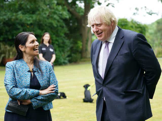 <p>Boris Johnson and his home secretary, Priti Patel, at Surrey Police headquarters on Tuesday</p>