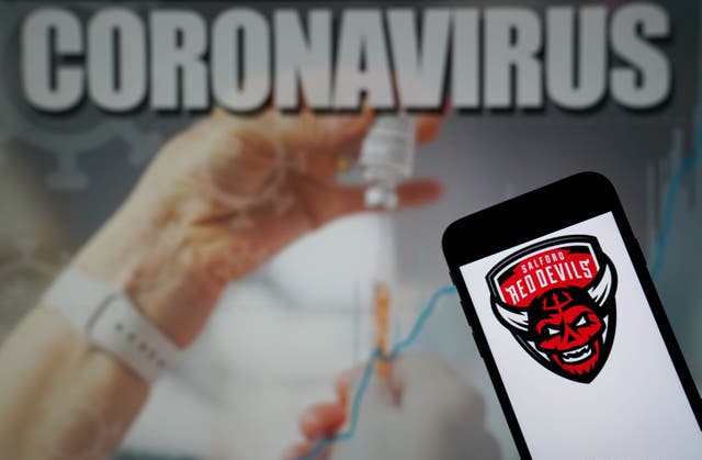 File photo dated 09-01-2021 of The Salford Red Devils logo seen displayed on a mobile phone with a Coronavirus illustration on a monitor in the background. Issue date: Tuesday June 22, 2021.