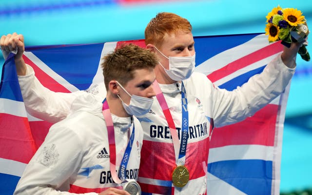 Great Britain’s Tom Dean (right) with his gold medal celebrates after winning the Men’s 200m Freestyle alongside second placed silver medalist Great Britain’s Duncan Scott (Joe Giddens/PA)