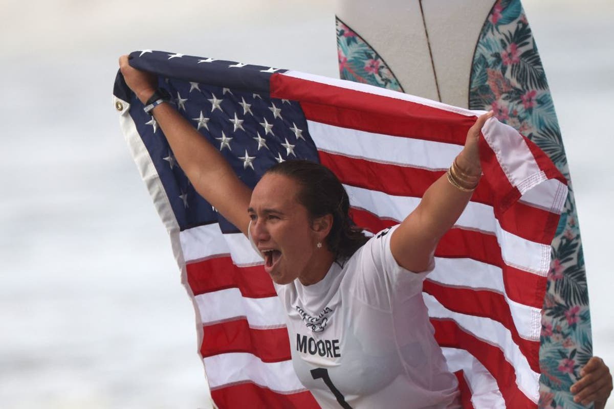US surfer Carissa Moore wins Olympic Gold after becoming local favourite with thank you speech in Japanese