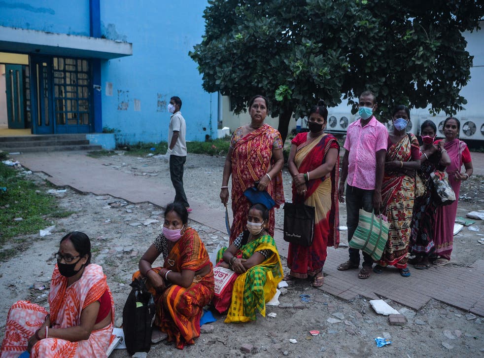 <p>FILE. People stand in a queue as they wait for a Covid-19 coronavirus vaccine at the North Bengal Medical college and hospital on the outskirts of Siliguri on 26 July, 2021. </p>