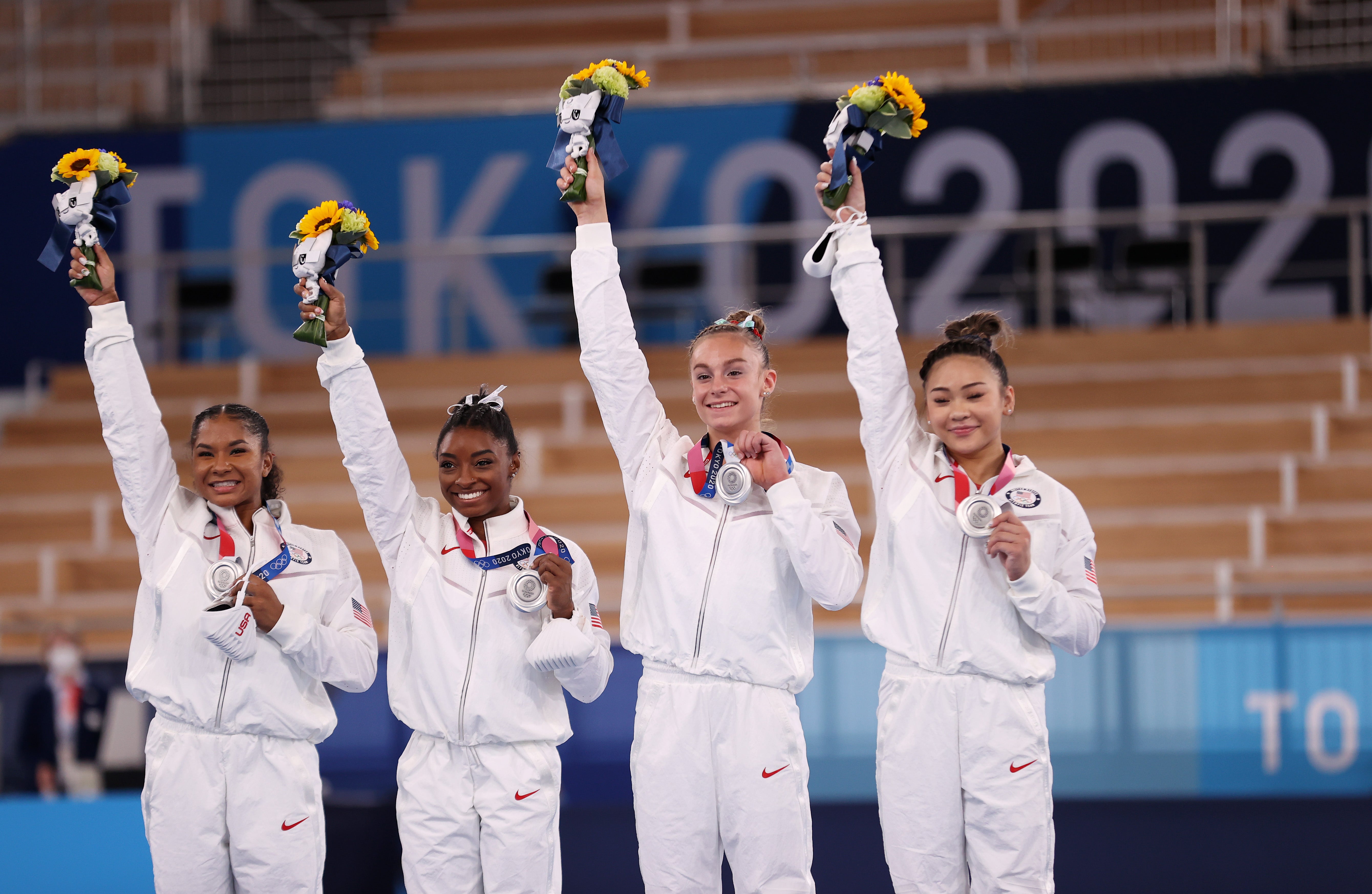 Jordan Chiles, Simone Biles, Grace McCallum and Sunisa Lee of Team United States react on the podium after winning the silver medal during the Women's Team Final on day four of the Tokyo 2020 Olympic Games at Ariake Gymnastics Centre on 27 July 2021 in Tokyo, Japan