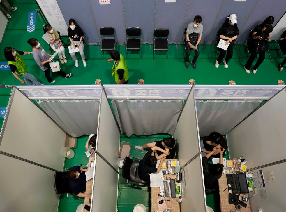 <p>File photo: People receive the first dose of the Pfizer-BioNTech Covid-19 coronavirus vaccine at a vaccination center in Seoul on 28 July</p>