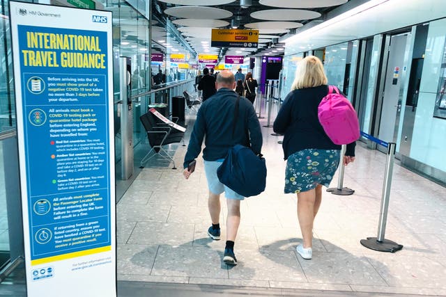 <p>Jab or quarantine? Passengers arriving at Heathrow Terminal 5</p>
