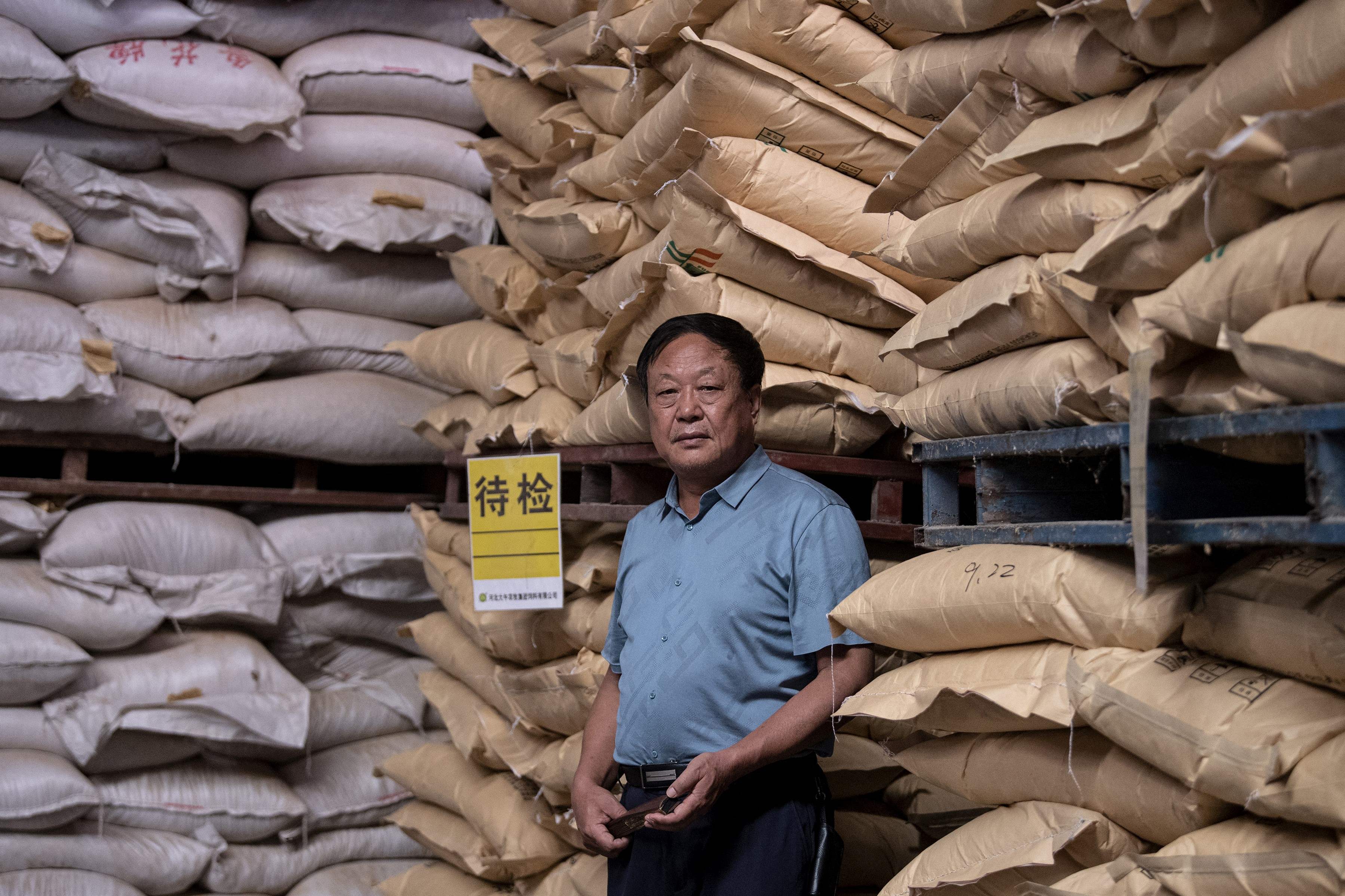 File: Chinese pig farmer and billionaire Sun Dawu posing at a feed warehouse in Hebei on 24 September, 2019