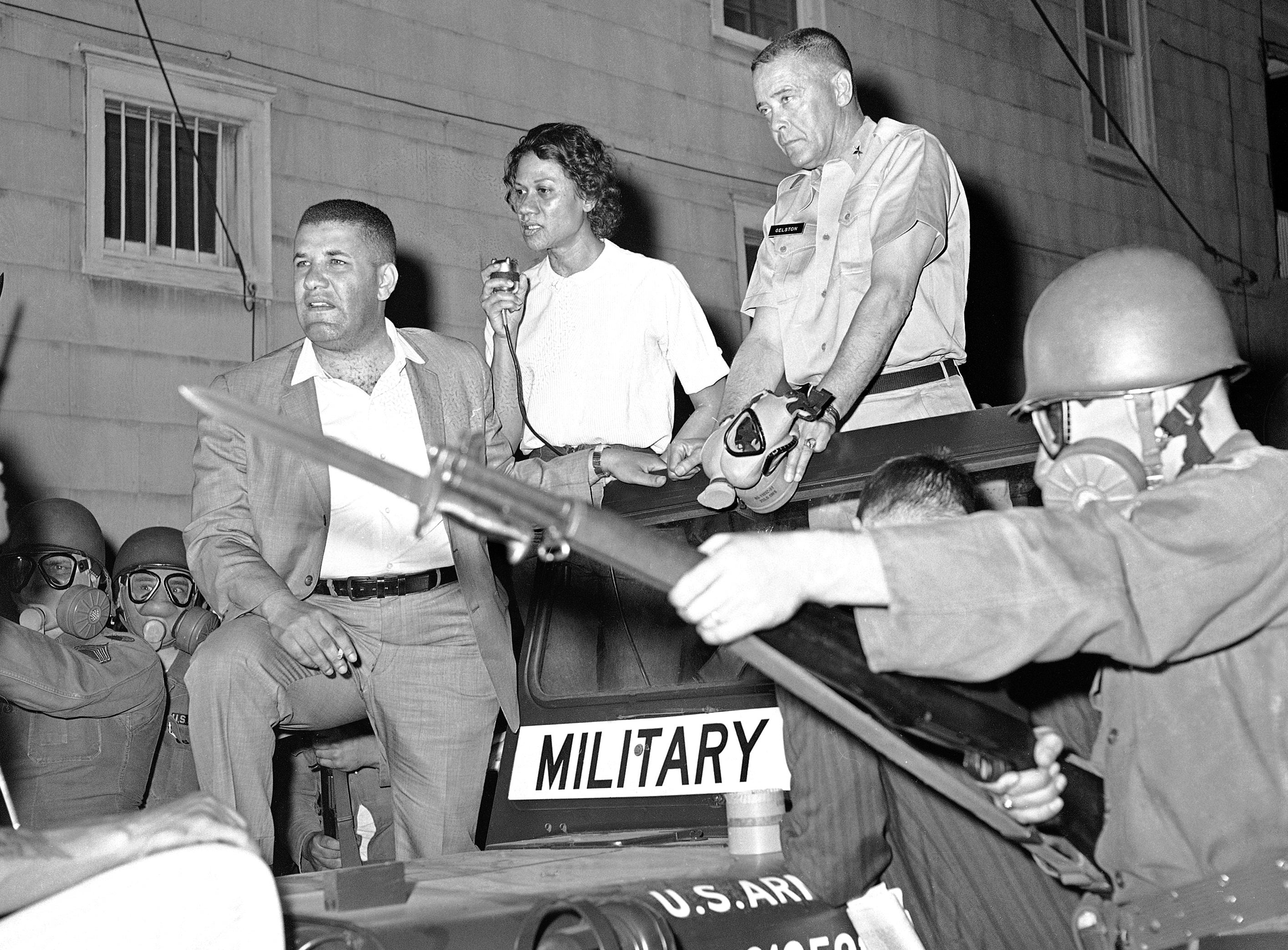 With her fellow activists Richardson faces down masked National Guardsman in 1963