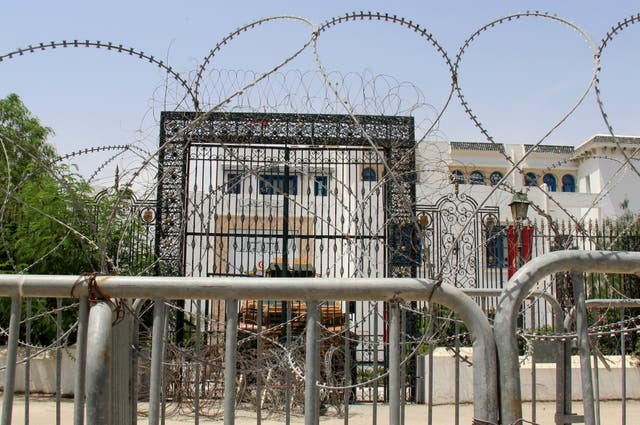 <p>Barbed wire and a military armored personnel carrier block a side entrance of the Tunisian parliament</p>