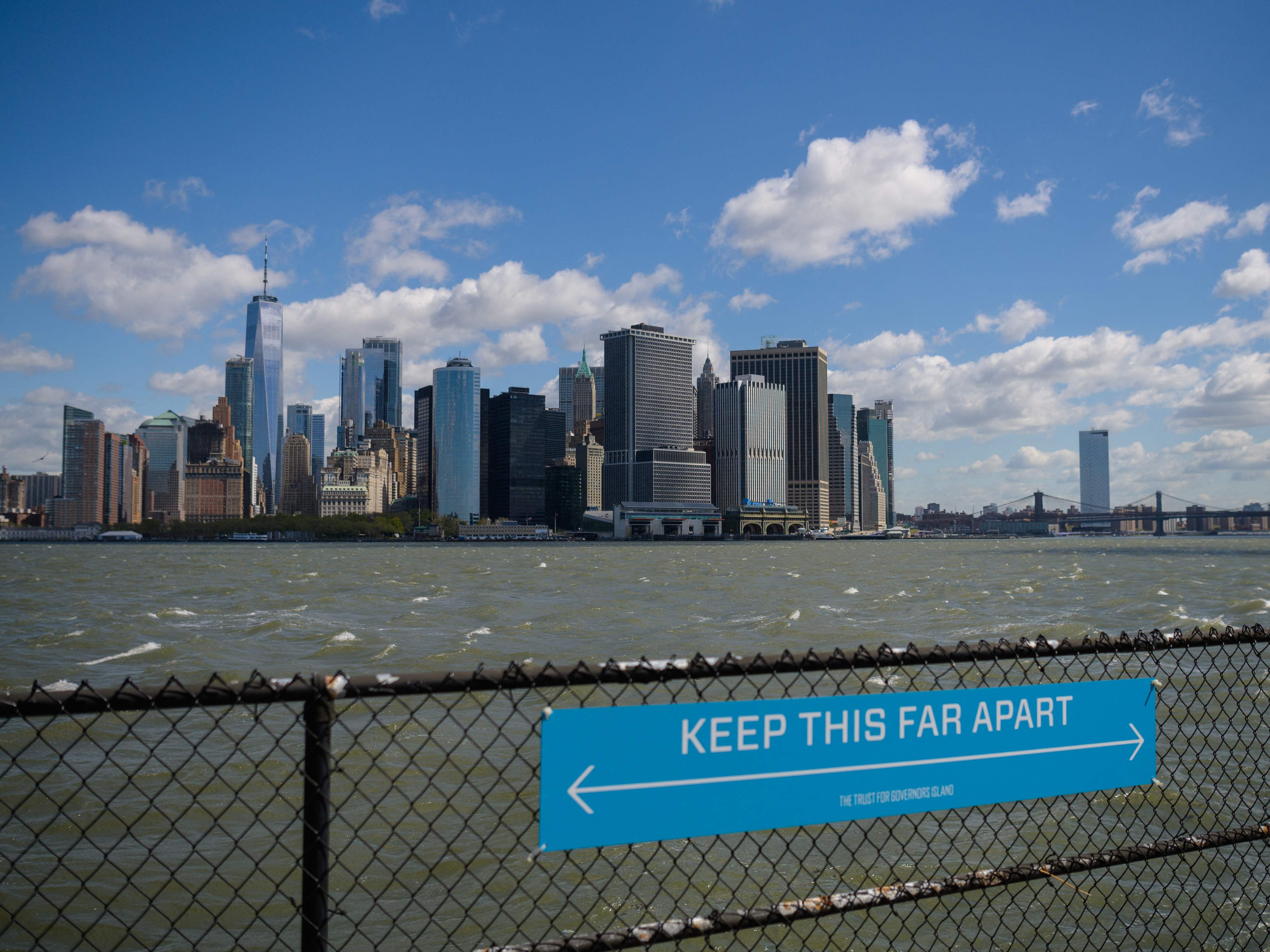 <p>In this file photo a sign to promote social distancing is seen on Governors Island on 30 April 2021 in New York City</p>