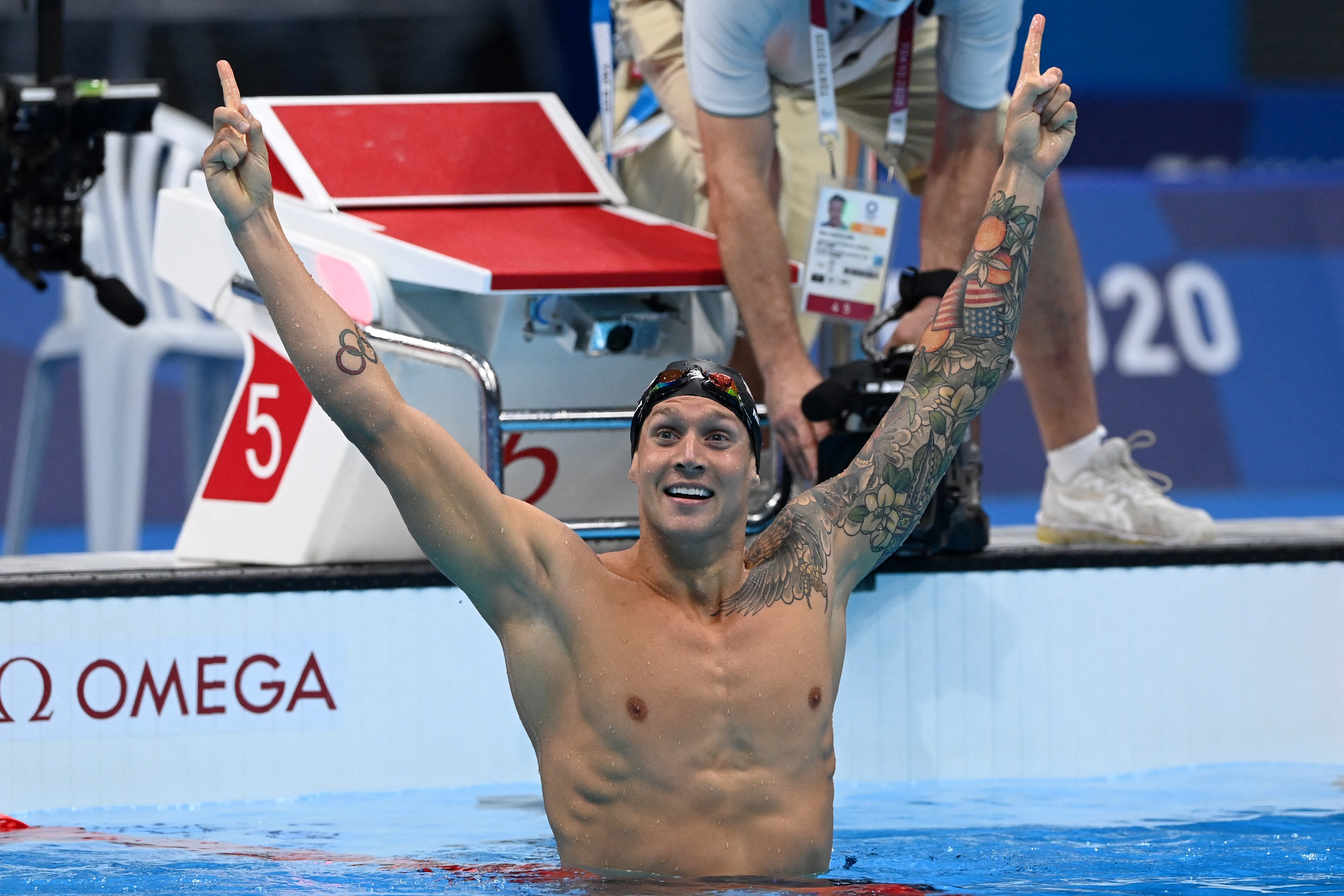 USA's Caeleb Dressel celebrates winning to take gold in the final of the men's 100m freestyle swimming event during the Tokyo 2020 Olympic Games at the Tokyo Aquatics Centre in Tokyo on July 29, 2021.