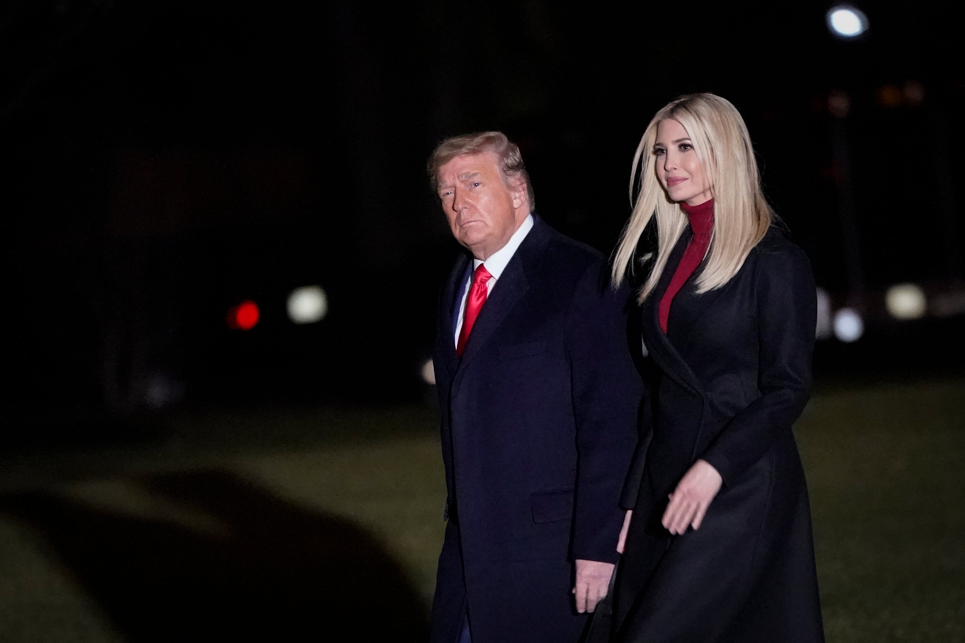 File: Donald Trump and three of his adult children are accused of exploiting their family name to promote a marketing scam targeting the poor and working class