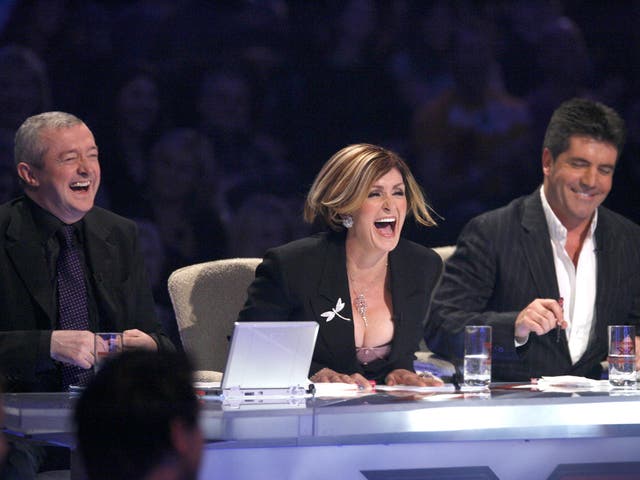 <p>Louis Walsh, Sharon Osbourne and Simon Cowell at the judges’ table on ‘The X Factor’ in 2005</p>