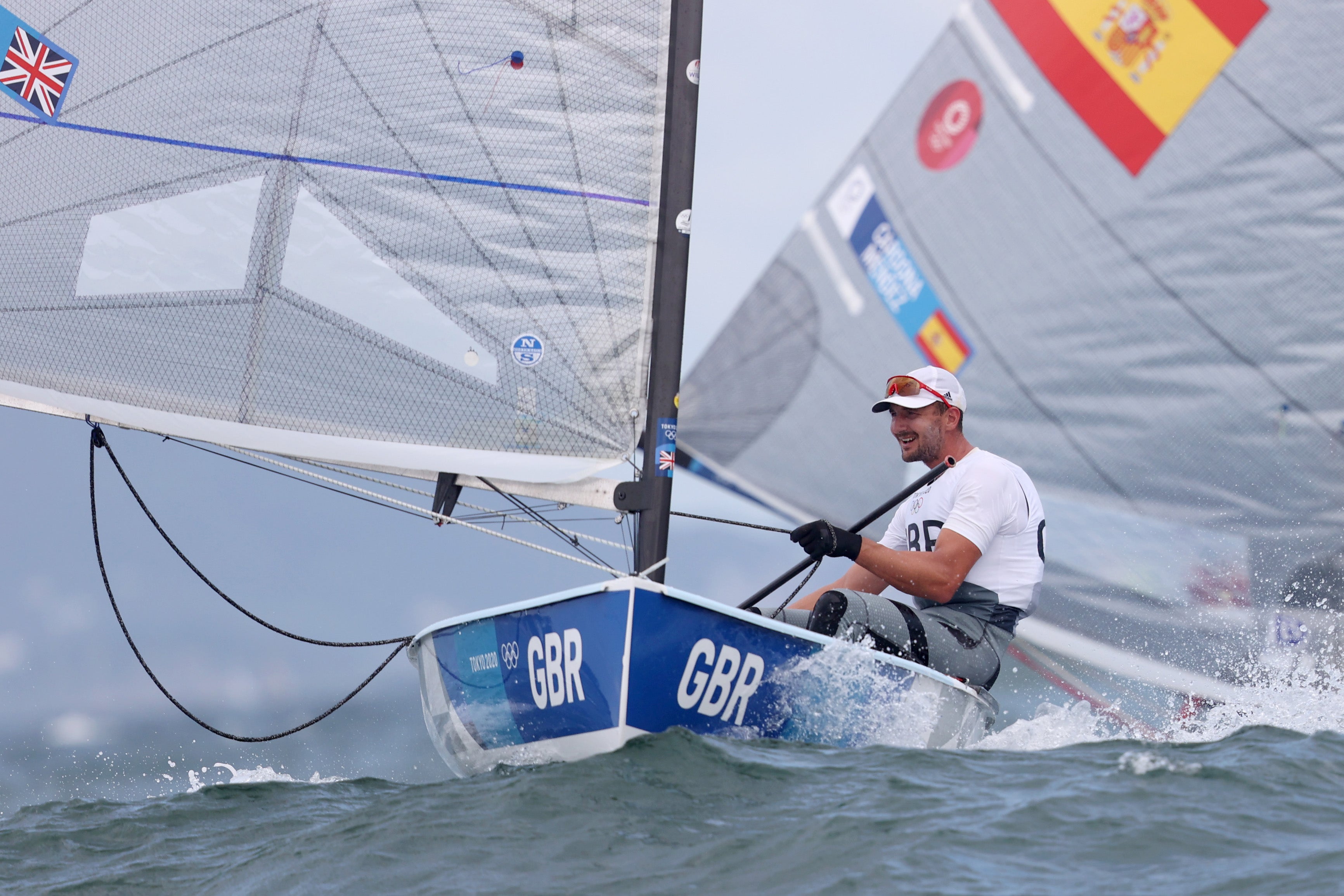 Giles Scott of Team Great Britain competes in the Men's Finn class on day six