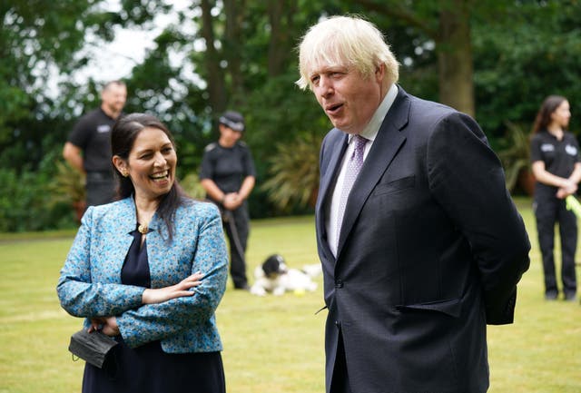 <p>Boris Johnson and Priti Patel during a visit to Surrey Police headquarters on Tuesday</p>