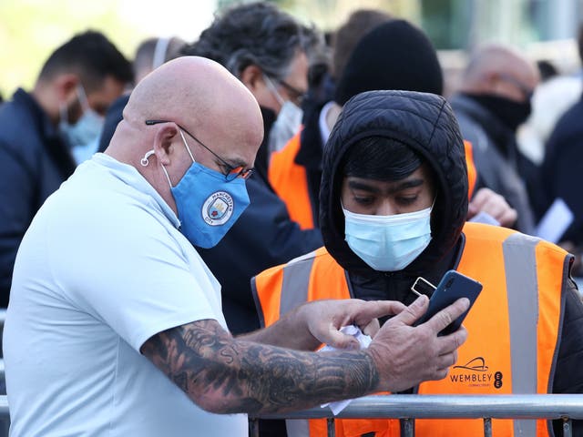 <p>Football fan shows Covid certification to get into Wembley</p>