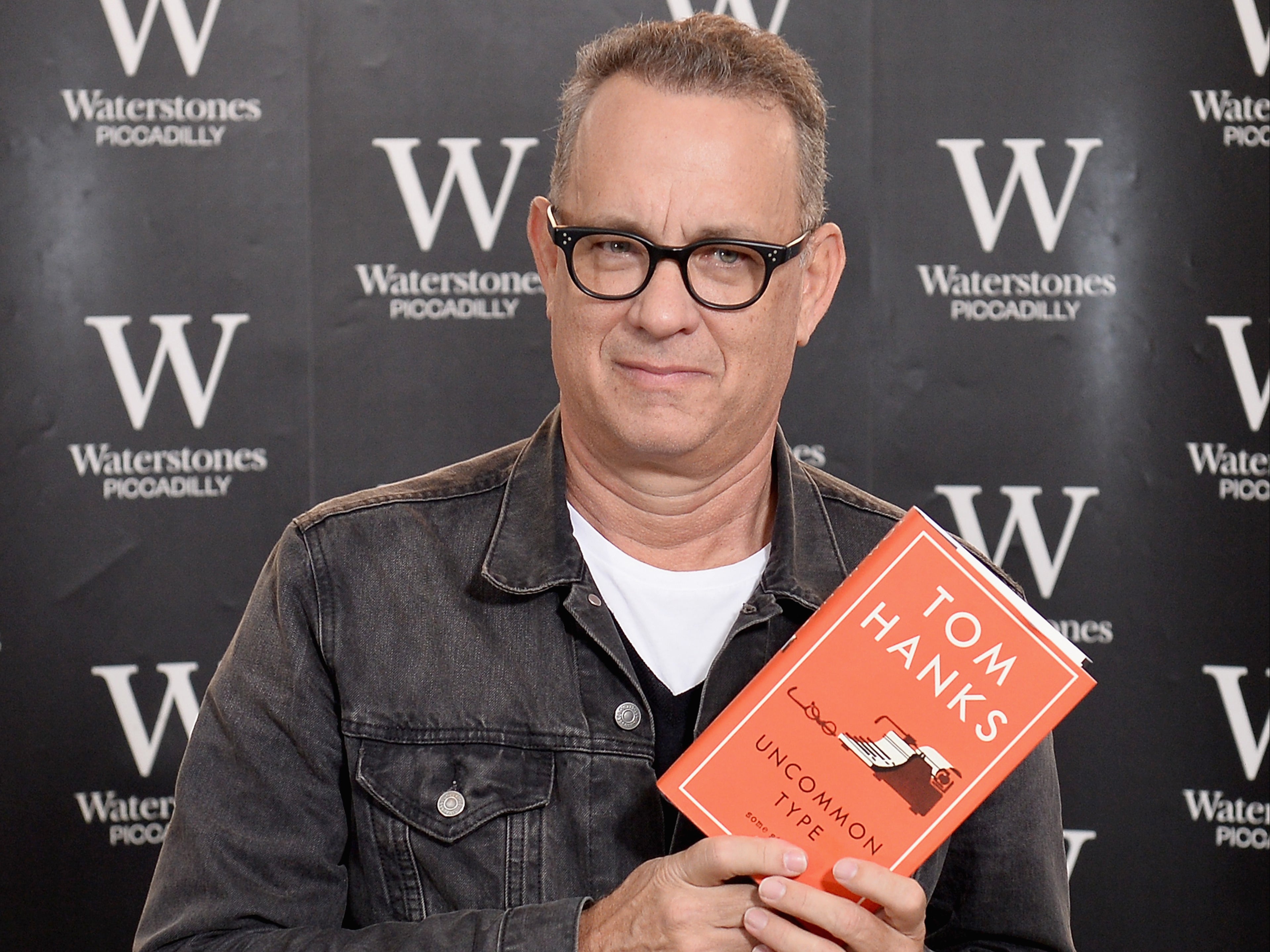 Hanks for the memories: The ‘Forrest Gump’ star poses with his 2017 short story collection ‘Uncommon Type'