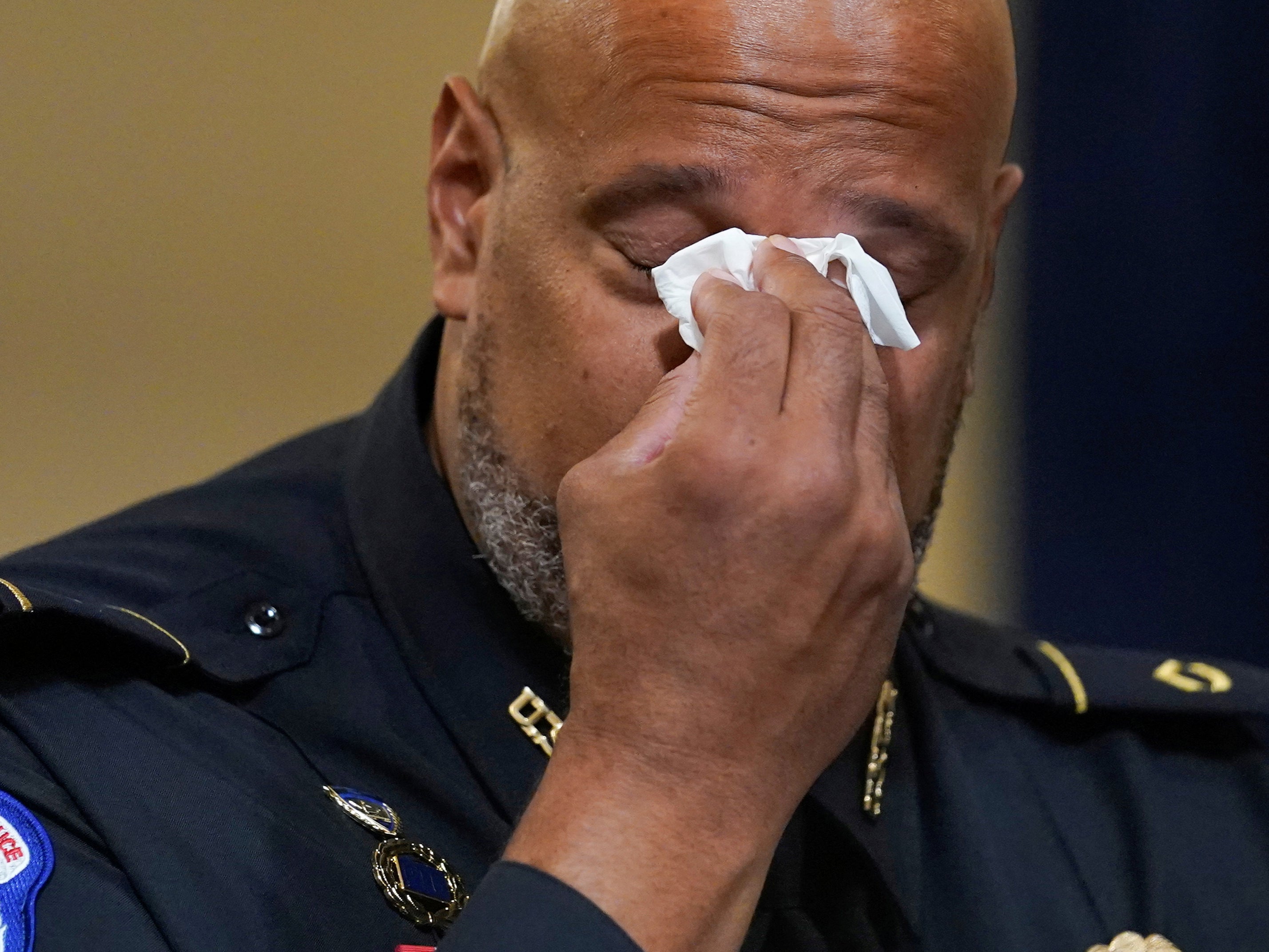 <p>US Capitol Police Seargent Harry Dunn wipes his eyes during the House select committee hearing on the 6 January attack on Capitol Hill in Washington 27 July 2021</p>