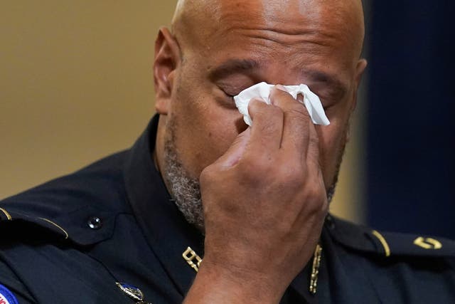 <p>US Capitol Police Seargent Harry Dunn wipes his eyes during the House select committee hearing on the 6 January attack on Capitol Hill in Washington 27 July 2021</p>