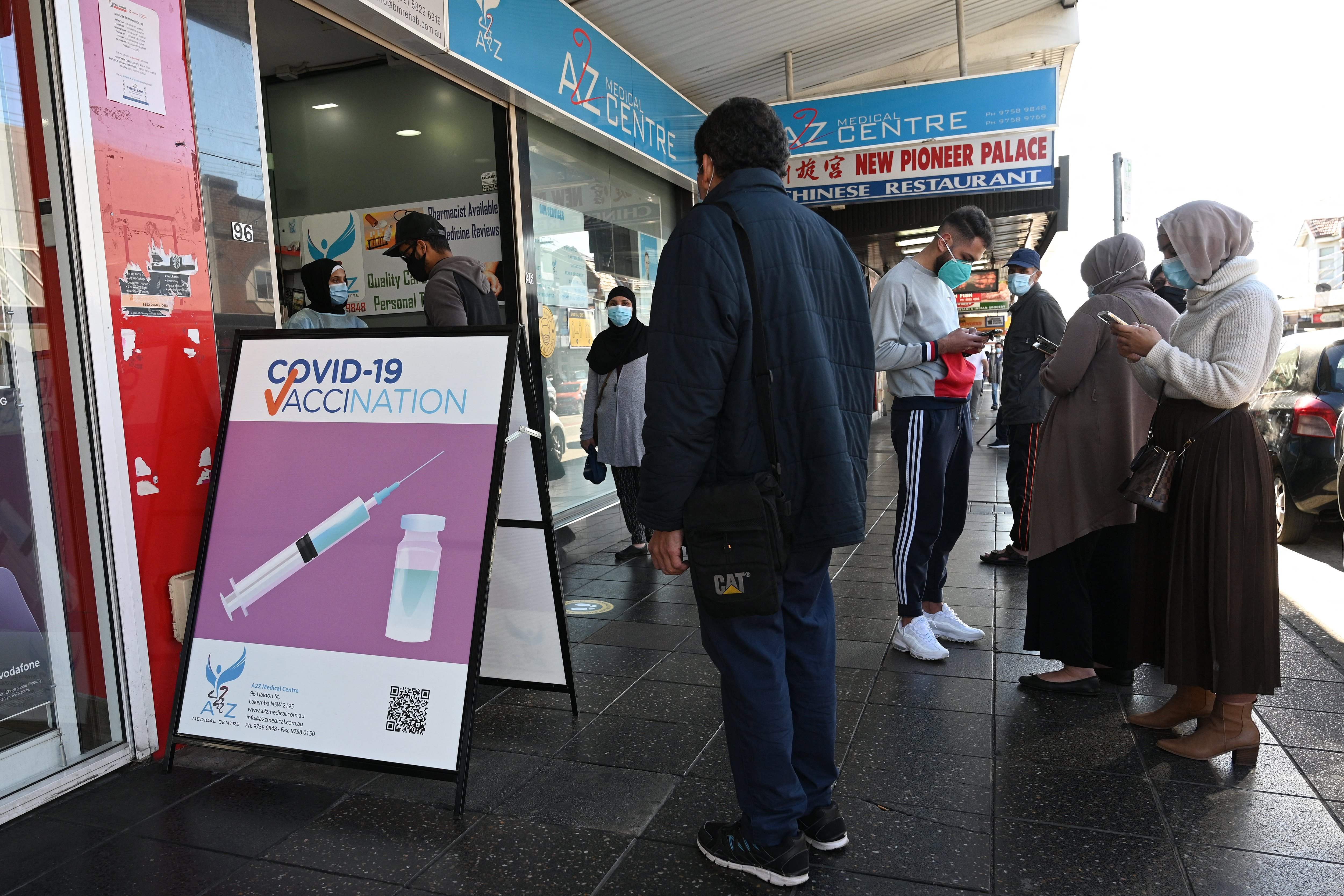 Residents queue up outside a pharmacy for a Covid-19 vaccination in western Sydney