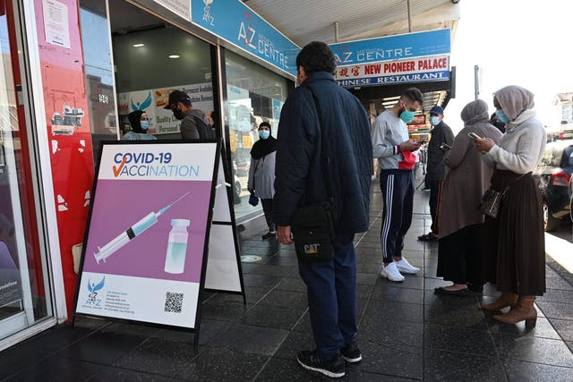 <p>Residents queue up outside a pharmacy for a Covid-19 vaccination in western Sydney</p>