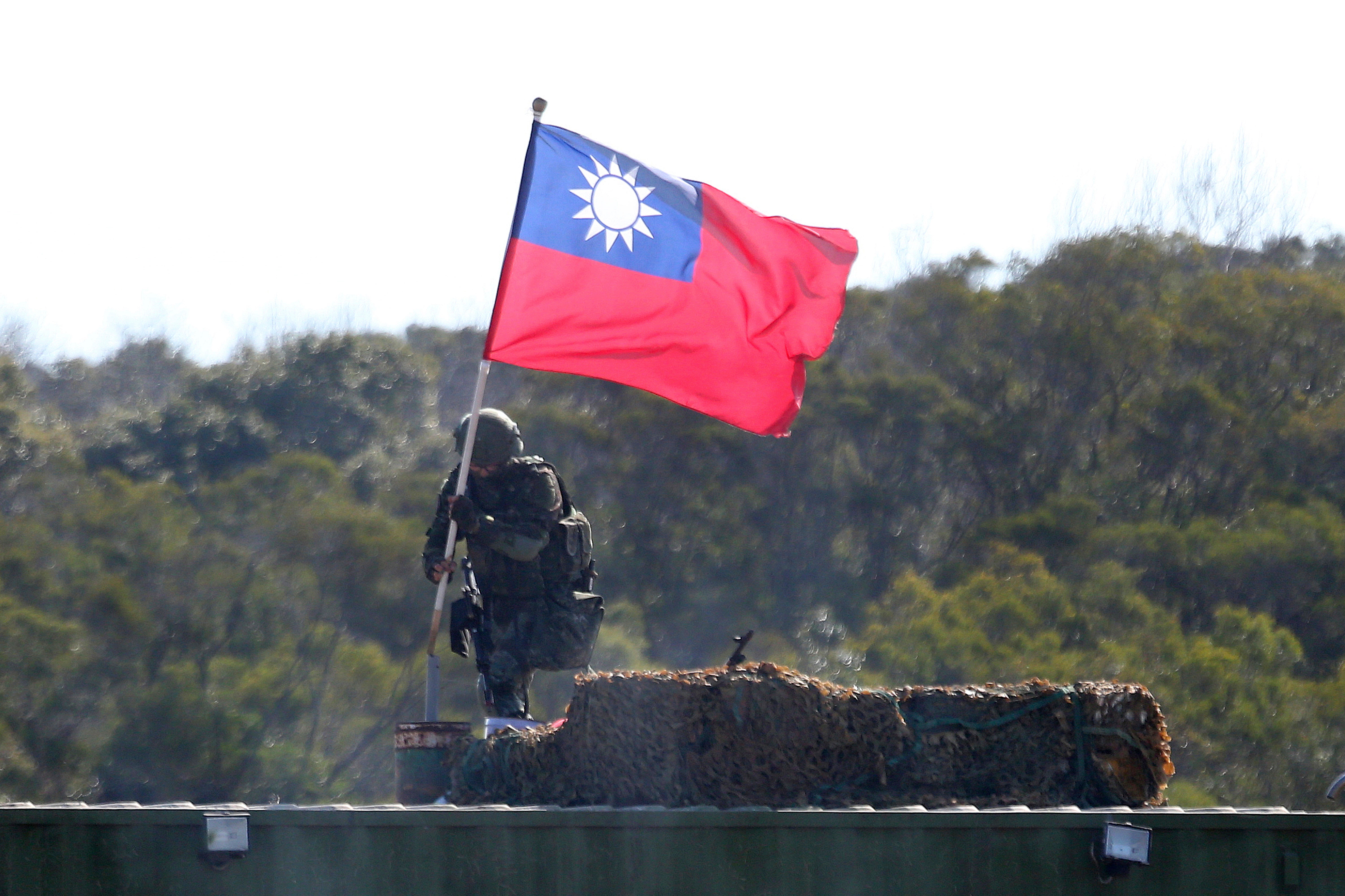 A soldier holds a Taiwanese flag