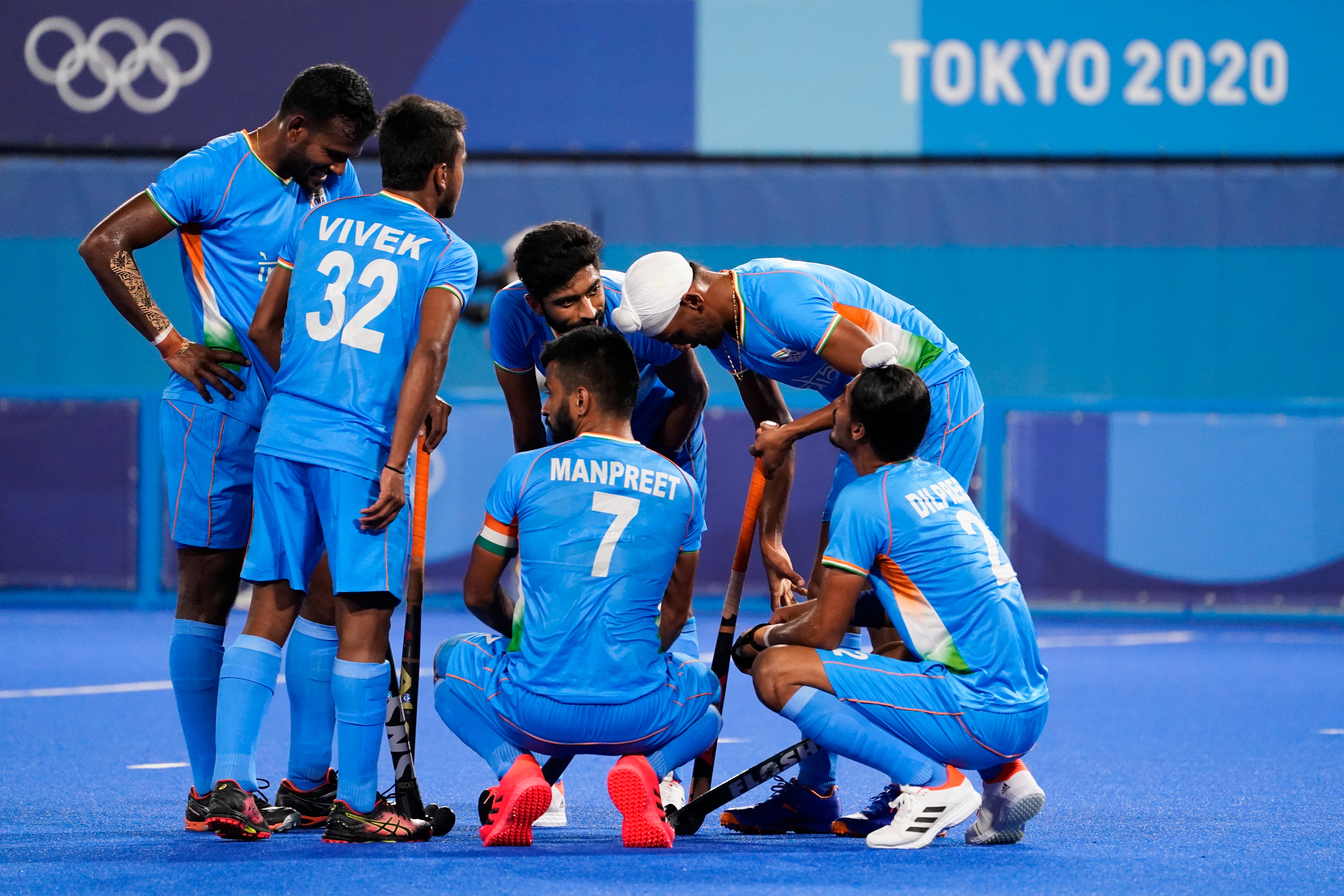 India's Manpreet Singh (7) huddles with his teammates after conceding the sixth goal to Australia