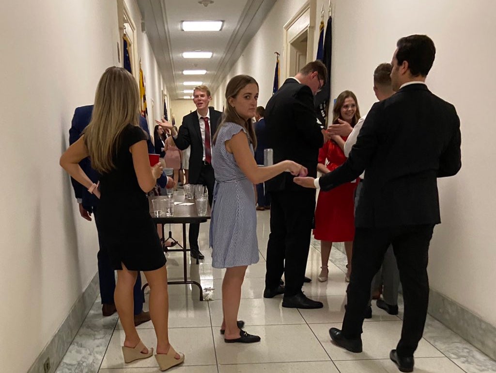 <p>Aaron Fritschner, the Deputy Chief of Staff for Virginia representative Don Beyer, posted images of a group of people gathered in a hallway on Twitter on Thursday</p>