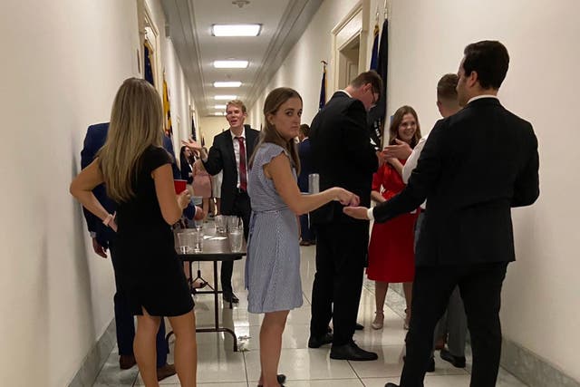 <p>Aaron Fritschner, the Deputy Chief of Staff for Virginia representative Don Beyer, posted images of a group of people gathered in a hallway on Twitter on Thursday</p>