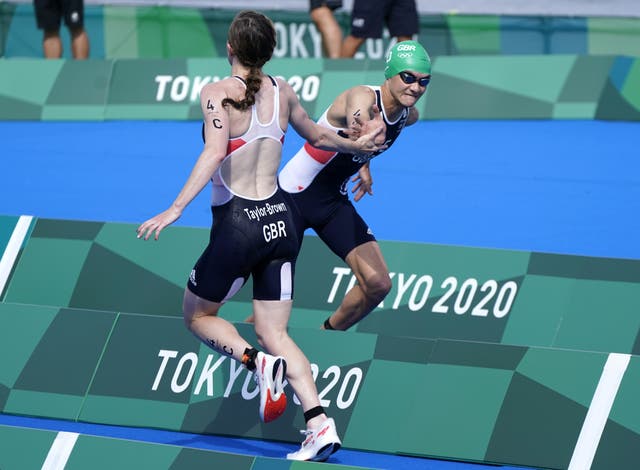 <p>Georgia Taylor-Brown hands over to team-mate Alex Yee in Tokyo 2020. The triathletes are both favourites at this year’s games in Birmingham (Danny Lawson/PA)</p>